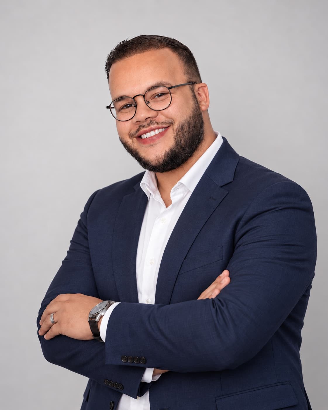Portrait of Kevin Cintron in a navy blazer